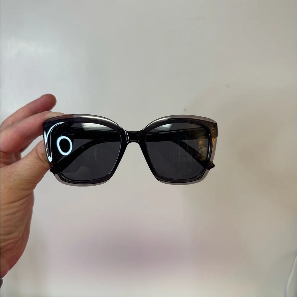 Black plastic frame with black tint. No case